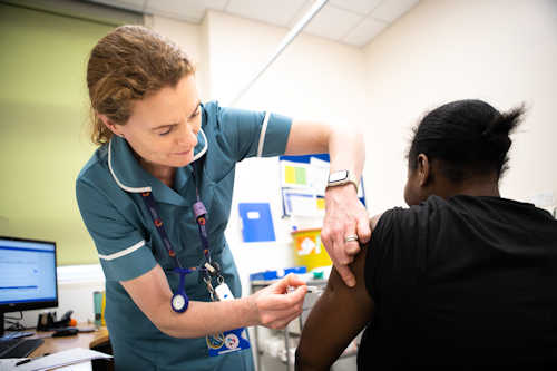 Midwife giving vaccination